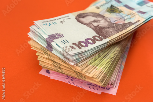 new 1000 banknote of 2020 year, ukraine money uah isolated on orange.