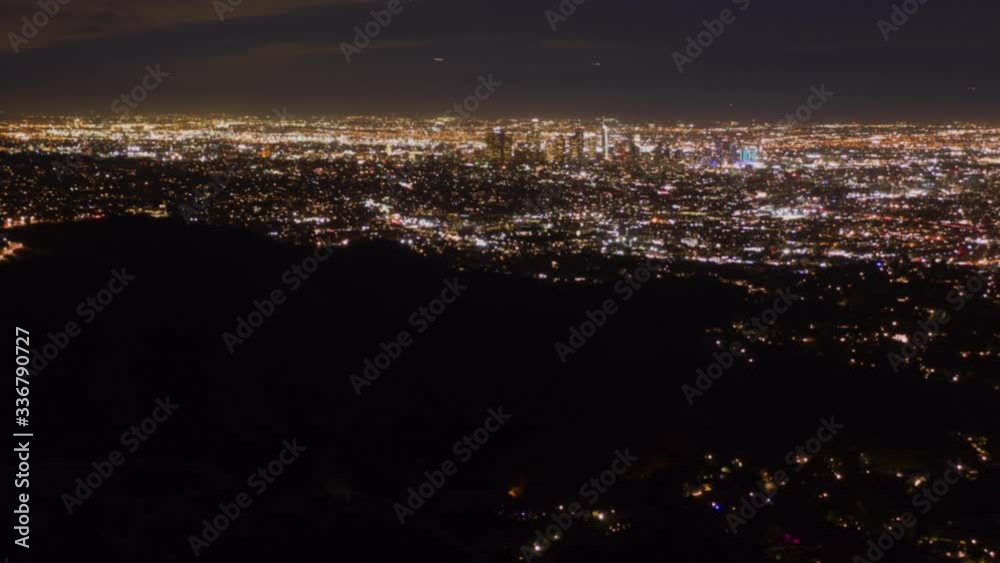 AERIAL HYPER LAPSE: Over Hollywood Sign at Night in Los Angeles, California at Night with Glowing Cityscape Time Lapse AERIAL HYPER LAPSE: Over Hollywood Sign at Night in Los Angeles, California at Night with Glowing Cityscape Time Lapse