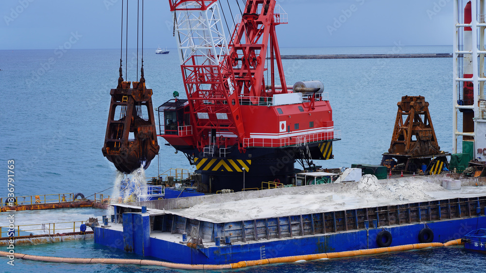 Sand Racking Japan a floating crane platform extracts white sand from the bottom of the ...
