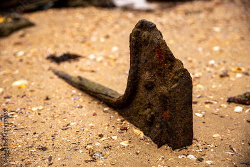 A Rusty Anchor on a Sandy Beach