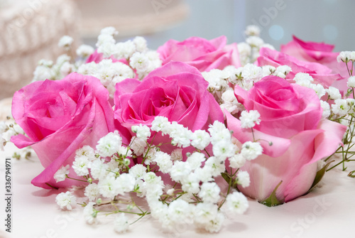 Close up of Pink roses on top of a cake