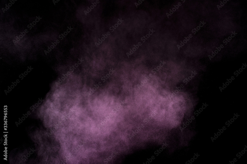 Purple powder explosion on black background. Colored powder cloud. Colorful dust explode. Paint Holi.