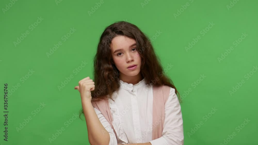 Get out! Upset irritated teenage brunette girl in white shirt pointing away, asking to leave her, feeling betrayed and vexed, quarrel in adolescence. indoor studio shot isolated on green background Get out! Upset irritated teenage brunette girl in white shirt pointing away, asking to leave her, feeling betrayed and vexed, quarrel in adolescence. indoor studio shot isolated on green background