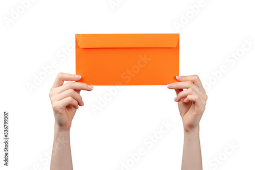 Female hand with manicure holding envelope isolated on white background