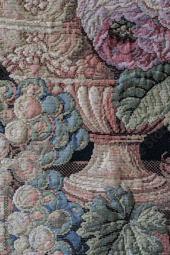 Old medieval gothic style intricate muted coloured tapestry wall hanging showing fruits and flowers.