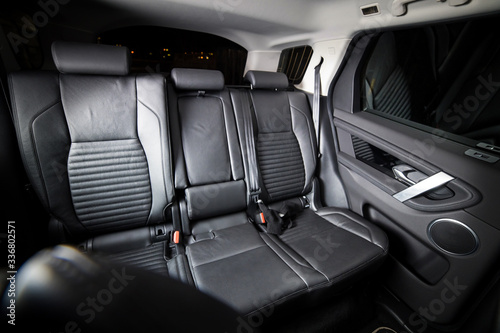 Dark luxury new car Interior. Back passenger seats in modern car. Leather backseats and seatbelts © Dmitry Dven
