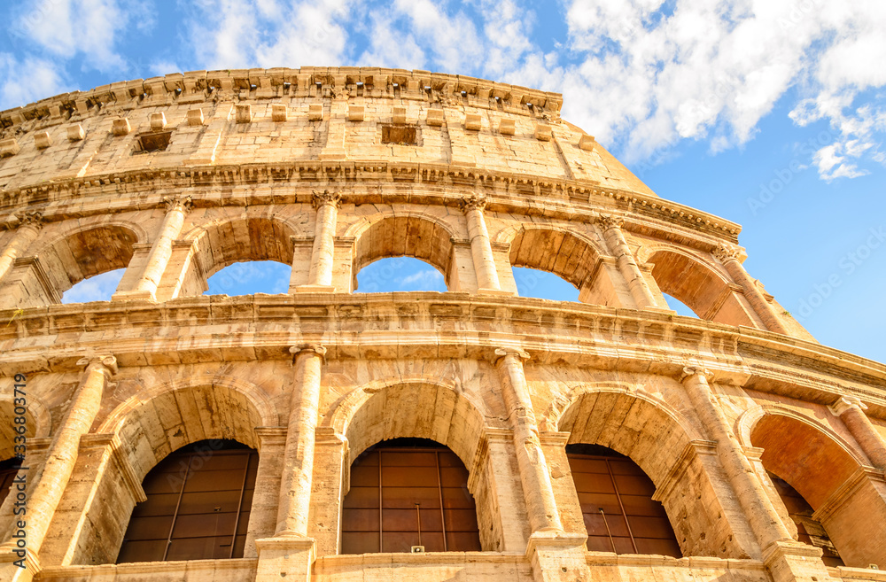 Naklejka premium Italian spring walks. The spring sun illuminating the coliseum in Rome.