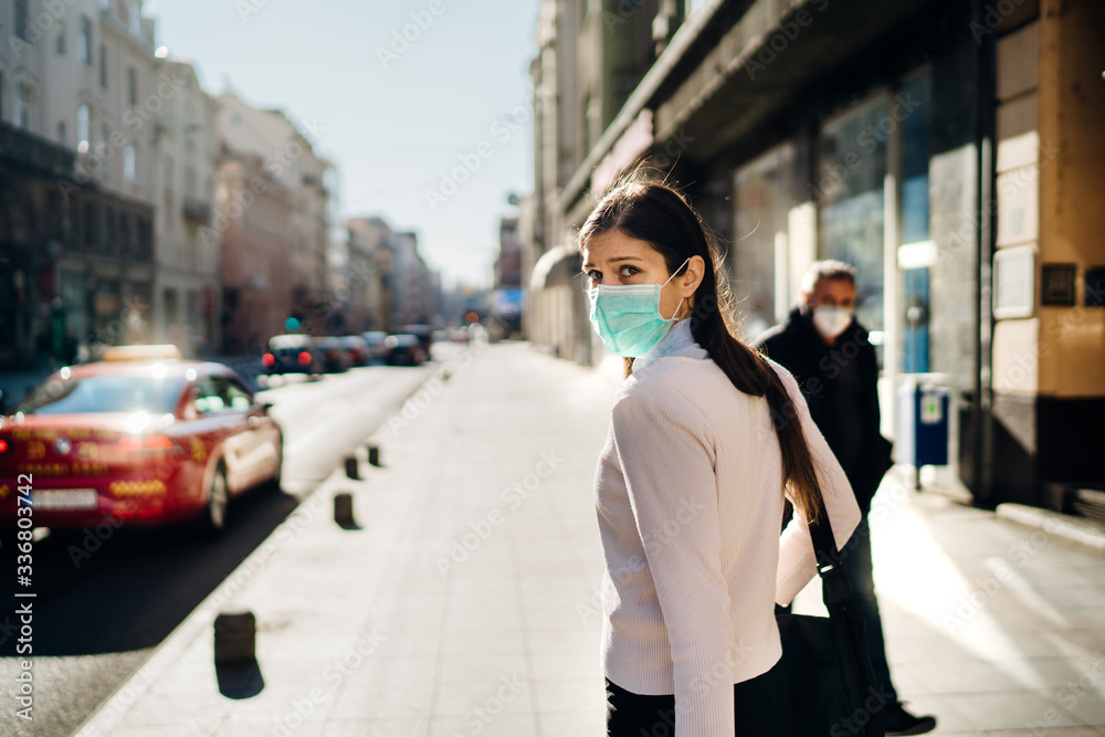 Anxious young adult affected by the COVID-19.Walking,going to work during pandemic.Protective measures,mask wearing.Respecting guidelines.Avoiding contact.Fear of coronavirus.Emotional effect