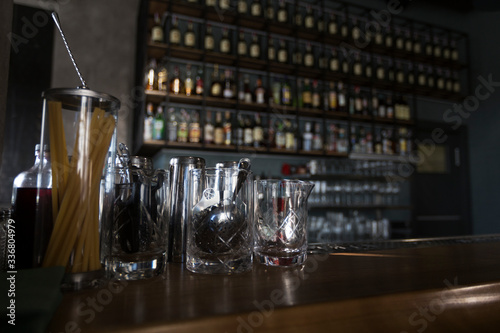 Cafe with half-lighted bar counter full of luxury alcohol