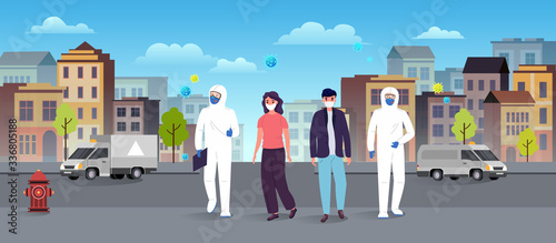 Medics in protective suits help people