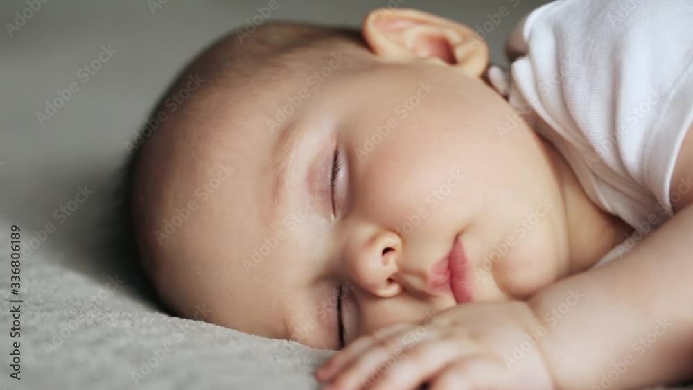 Sleeping cute baby boy on gray blanket Sleeping cute baby boy on gray blanket