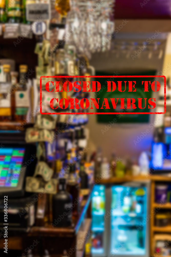 Defocused, blurred view of interior of traditional bar or pub, empty and closed due to coronavirus or covid 19 pandemics