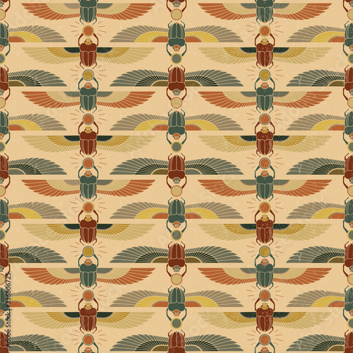 Symbols of ancient Egypt in the form of a nonsense pattern with an illustration of a scarab beetle with a sun symbol in its paws and wings.