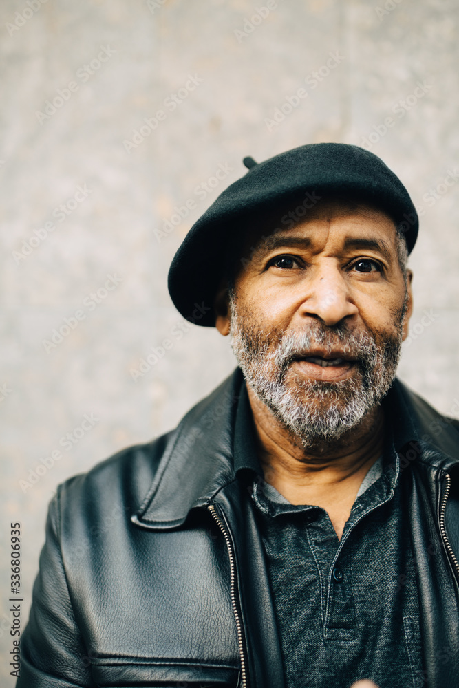 Portrait of senior man against wall Portrait of senior man against wall