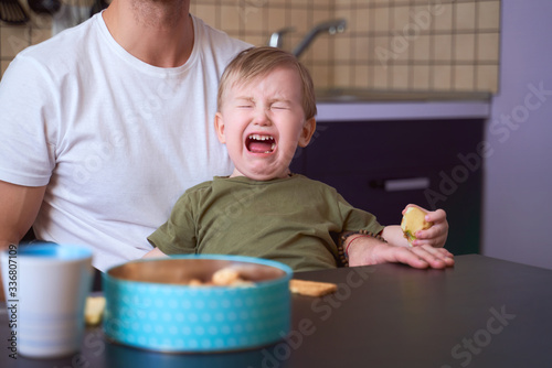 Small child bitterly bursts in tears, capricious, has bad mood, takes out brain of parents, tearfully asks to play, yells, throws tantrums. Day, kitchen. Tired of quarantine, wants to go outside.