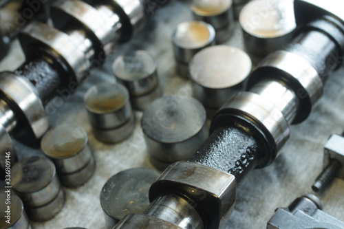 Camshaft and hydraulic compensators on the repair table. Close-up