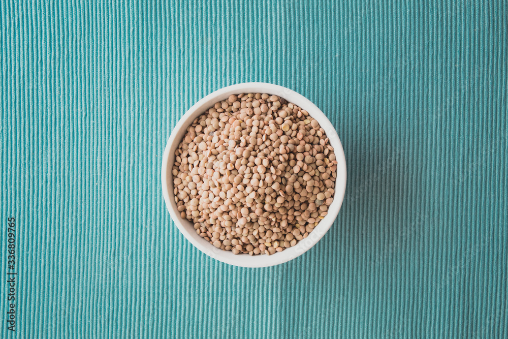Bowl of lentils on a green ground Bowl of lentils on a green ground