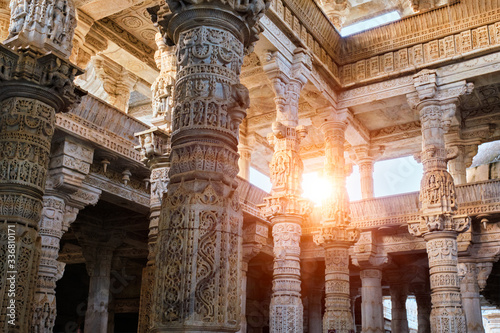 Columns pillars of beautiful Ranakpur Jain temple or Chaturmukha Dharana Vihara. Marble ancient medieval carved sculpture carvings of sacred place of jainism worship. Ranakpur, Rajasthan. India photo