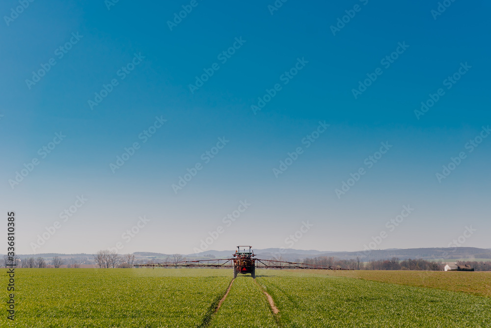 Tractor Spraying Herbicides on Field Agriculture