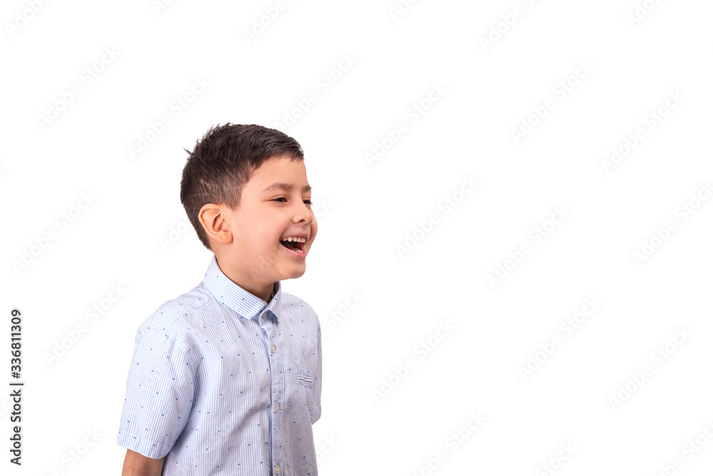 A cheerful young boy laughes at something and looks to the side, isolated A cheerful young boy laughes at something and looks to the side, isolated