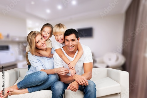 Beautiful smiling lovely family sitting on the sofa