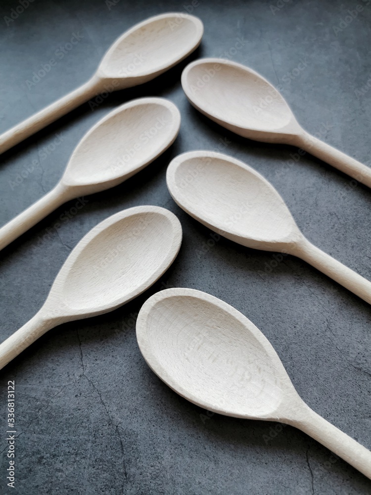 Wooden spoons on dark background. Top view. Copy space. Wooden spoons on dark background. Top view. Copy space.