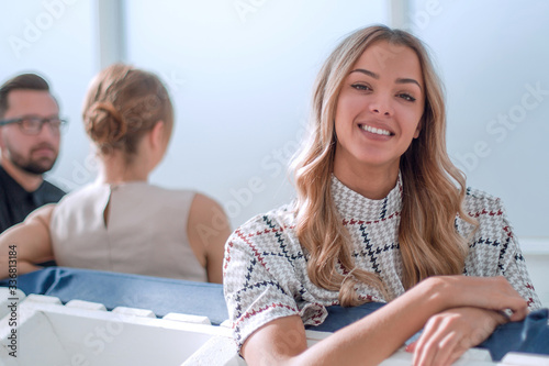 young business woman sitting in office lobby at coffee break