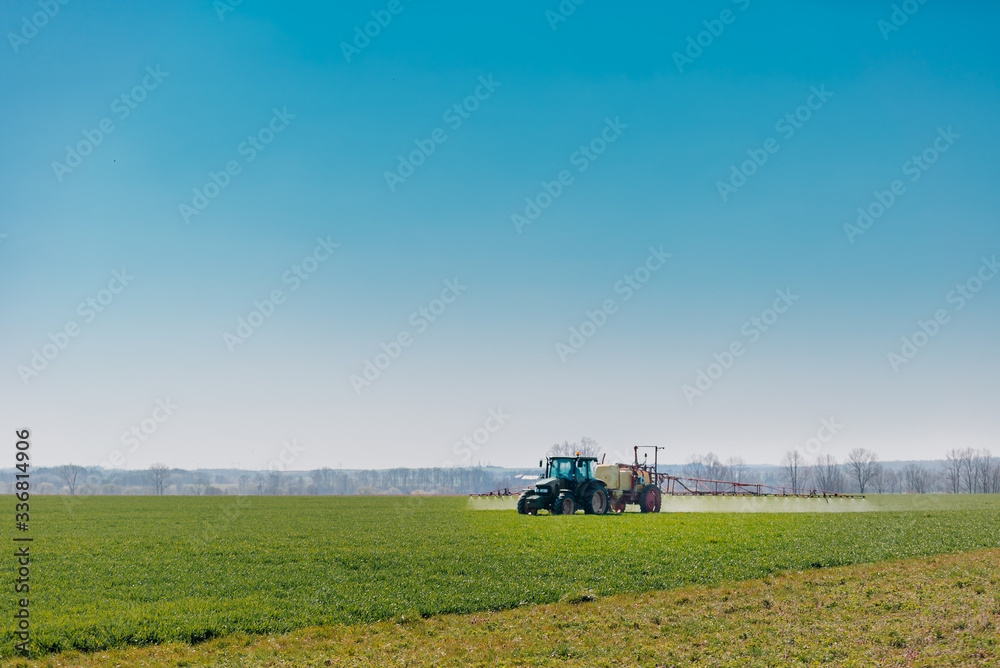Tractor Spraying Herbicides on Field Agriculture