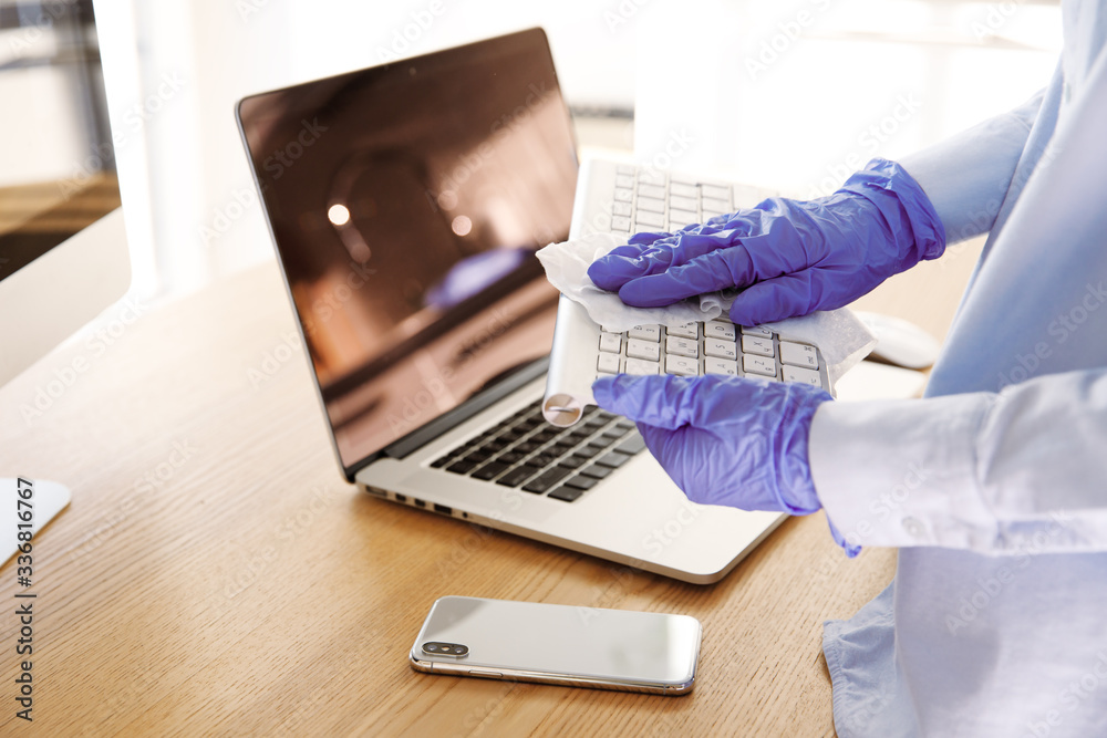 Close up blue latex gloves cleaning surface of workspace equipment with towel. Quarantine at home or office, step of prevention of coronavirus infection spread, sanitizing, disinfection, protection Close up blue latex gloves cleaning surface of workspace equipment with towel. Quarantine at home or office, step of prevention of coronavirus infection spread, sanitizing, disinfection, protection