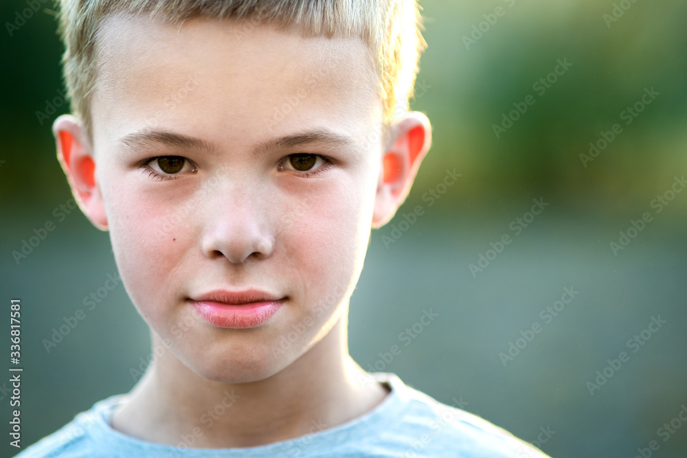 Portrait of a child boy outdoors on a warm sunny summer day.