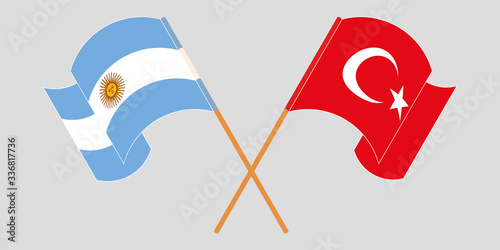 Crossed and waving flags of Turkey and Argentina