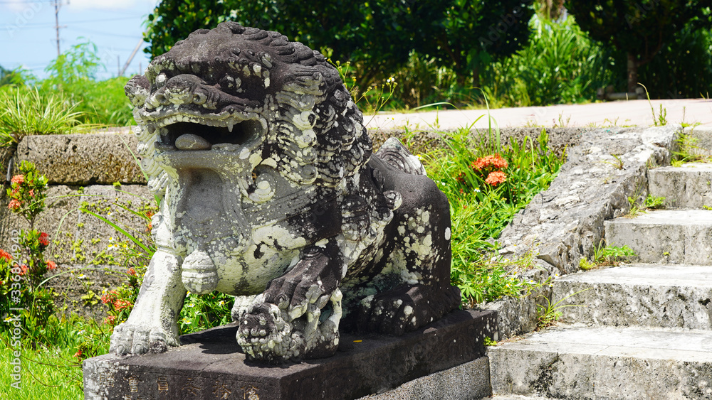 ancient japanese sculptures of mythical shisa on a green background Okinawa Japan