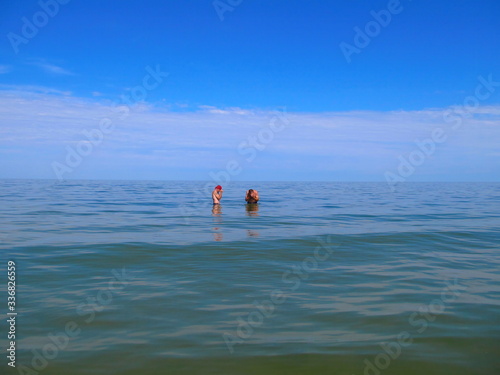 Two people in the sea during calm. Crimean peninsula.