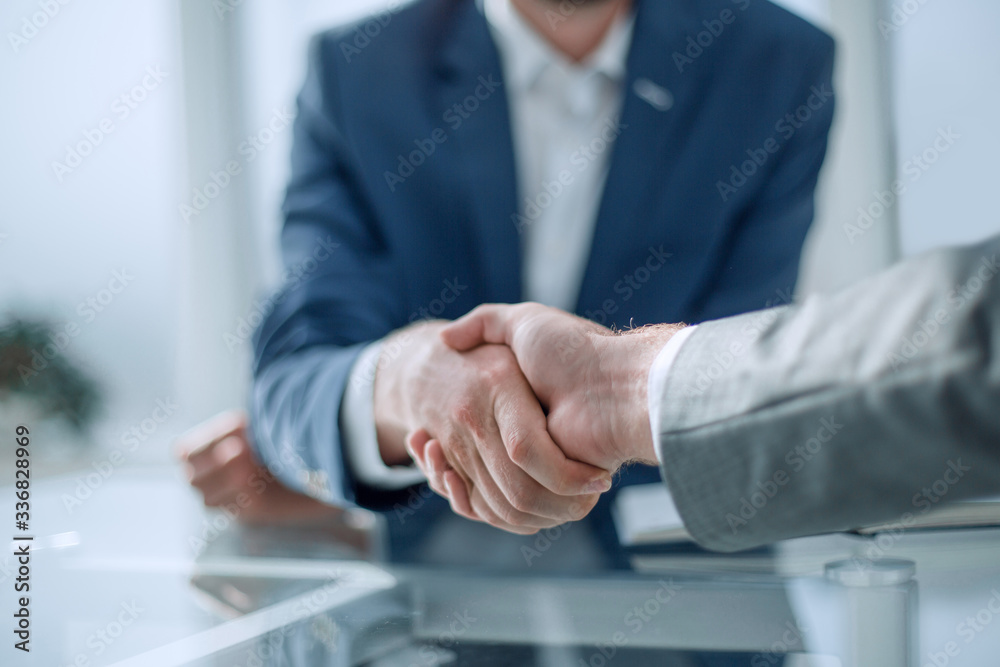 close up. business handshake over the office Desk close up. business handshake over the office Desk