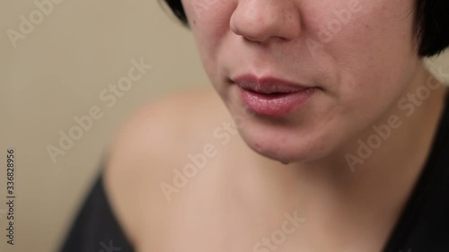 Young girl or teen lighting and smoking brass pipe with medical marijuana weed indoors and exhaling smoke with joy