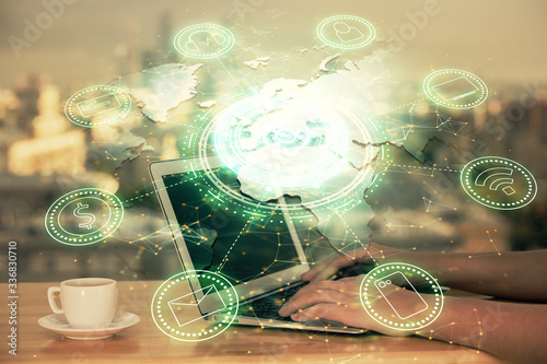 Double exposure of woman hands typing on computer and social network theme hologram drawing. People media concept. © peshkova