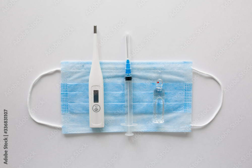 medical mask on a black background.face mask. mask for diseases. Thermometer and medication. the image of a single person. Medical breathing bandage on the face. The concept of quarantine coronavirus.
