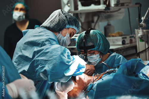 A team of surgeons is fighting for life, a real operation, real emotions. Intensive care team is fighting for the life of the patient. Saving life, the struggle for life. photo