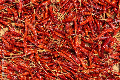 Red dry hot chili peppers for sale at street food market in Vietnam. Close up
