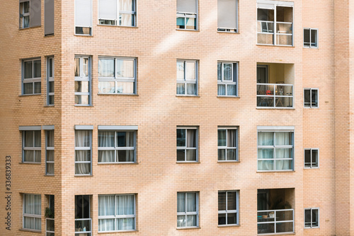 Overcrowded brick buildings with clean square windows.