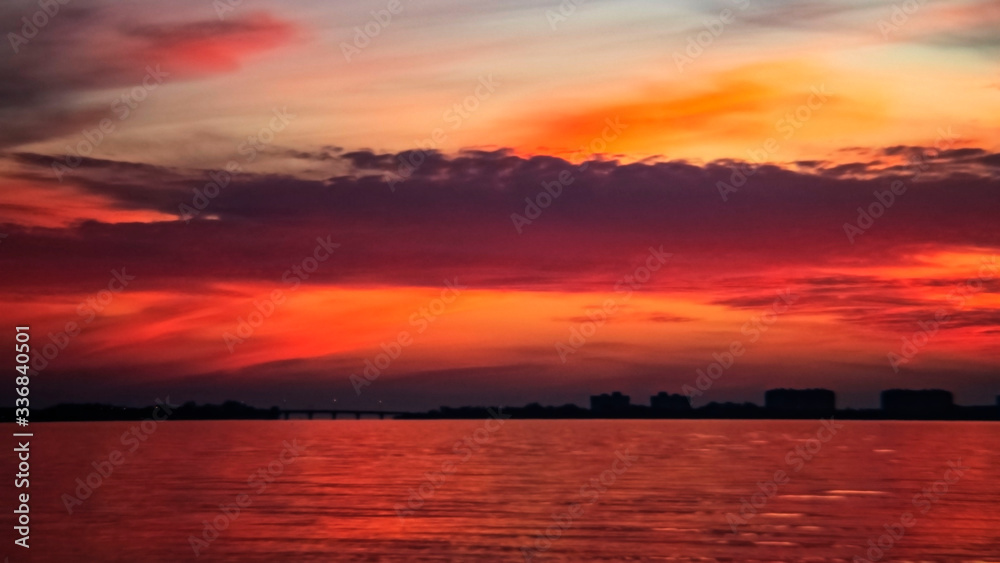 Red, orange sunset, water, reflection, skyline, horizon, Siesta Key, Sarasota, Florida