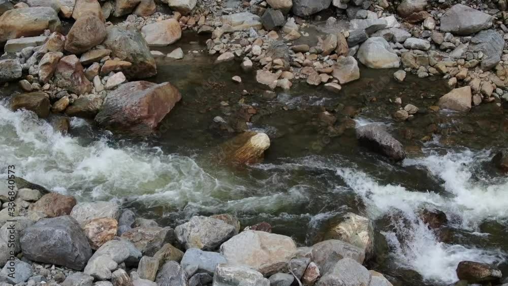Clean clear water flows from river through rock Clean clear water flows from river through rock