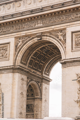 Architectural fragment of Arc de Triomphe. Arc de Triomphe de l'Etoile on Charles de Gaulle Place is one of the most famous monuments in Paris. © Aleksei Zakharov