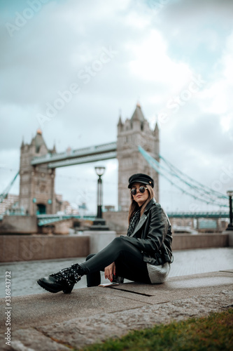 Girl walking on tower bridge on a beautiful blue sky day