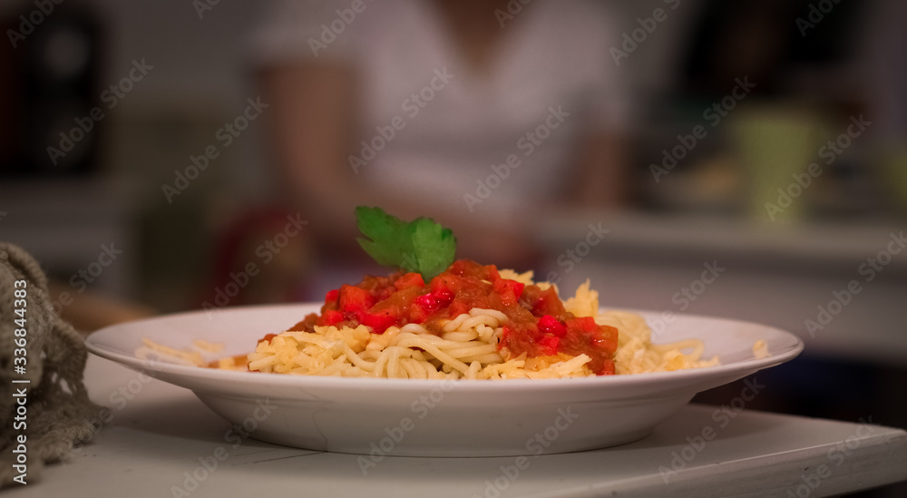 plate with spaghetti sauce and basil on white table plate with spaghetti sauce and basil on white table