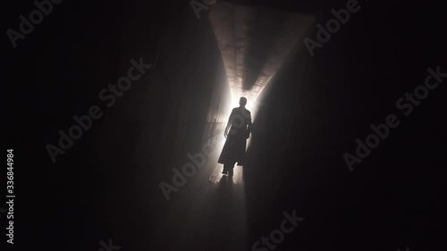 terrible silhouette of a thin tall man walks towards the camera