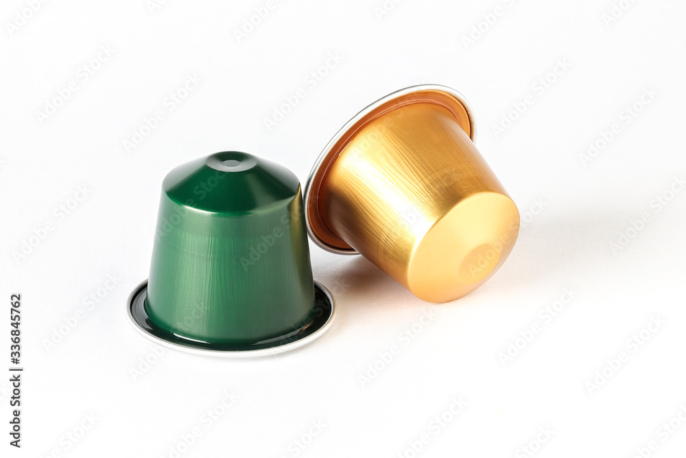 gold and green color espresso coffee capsules isolated on white background gold and green color espresso coffee capsules isolated on white background