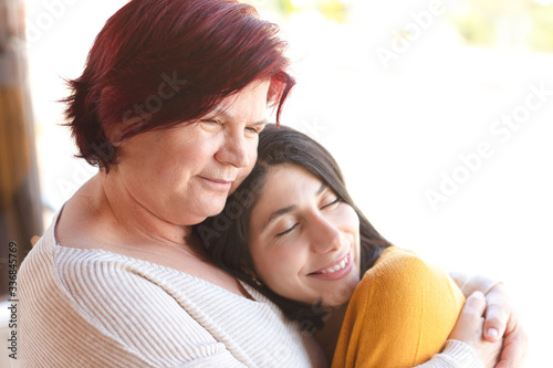 Positive, happy, loving senior mother and daughter embracing