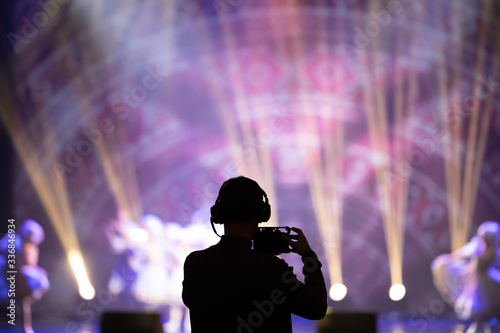 social media concept cameraman with crowd people exitied moment in colorful lighting concert event