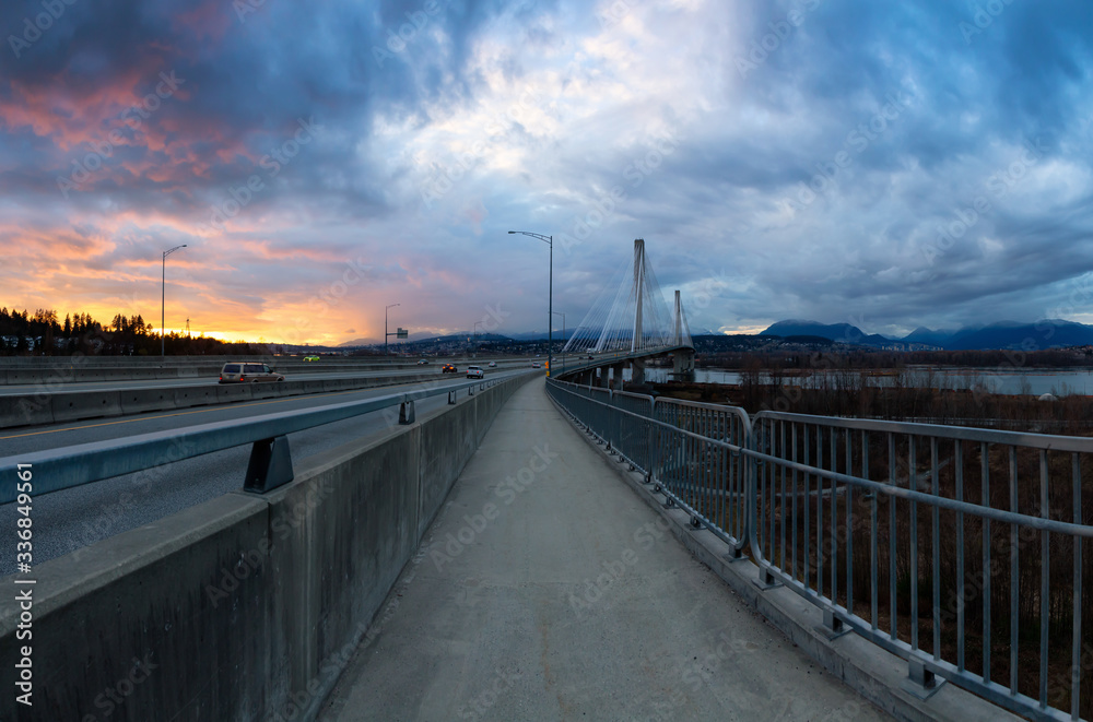 Panoramic View of a path on Port Mann Bridge during vibrant Sunset. Taken in Surrey, Vancouver, British Columbia, Canada.